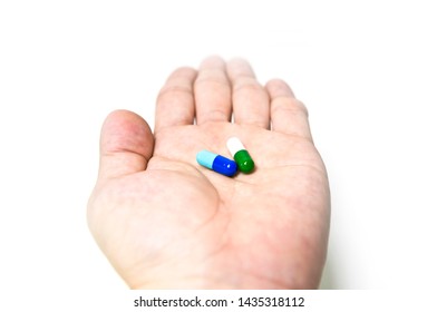 Drug Combination Therapy  For Orphan Diseases. Capsules On The Hand.