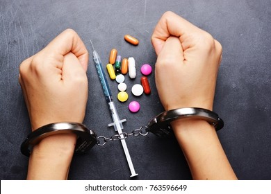 Drug Dealer Arrested For Prohibited Substances Trafficking, Handcuffed Person With Syringe And Colorful Pills