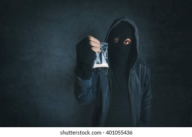 Drug dealer offering narcotic substance, unrecognizable hooded criminal selling drugs, addicted person point of view image