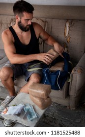 Drug Dealer Preparing Goods For Trafficking, Packing Cocaine Bricks, Pills And Marijuana Into A Duffle Bag