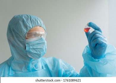 Drug Development Process, A Doctor In A Protective Suit Holds An Ampoule