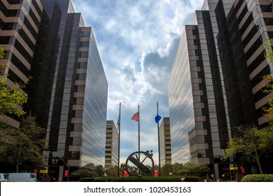 Drug Enforcement Administration (DEA) Museum & Visitors Center and Justice Federal Credit Union with flags and round sculpture in a center in Washington DC, USA