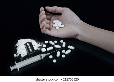 Drug Overdose Concept - Hand On Dark Table, Pills And Injection