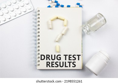 The DRUG TEST RESULT on the notepad next to the pill question mark. Compulsory drug testing, pill abuse. - Shutterstock ID 2198551261