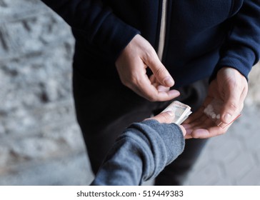 Drug Trafficking, Crime, Addiction And Sale Concept - Close Up Of Addict With Money Buying Dose From Dealer On Street