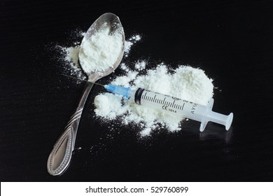 Drug Use, Addiction And Substance Abuse Concept - Close Up Of Spoon And Syringe With Crack Cocaine Drug Dose