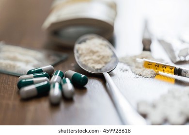 Drug Use, Crime, Addiction And Substance Abuse Concept - Close Up Of Drugs With  Money, Spoon And Syringe