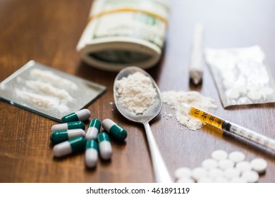 drug use, crime, addiction and substance abuse concept - close up of drugs with  money, spoon and syringe