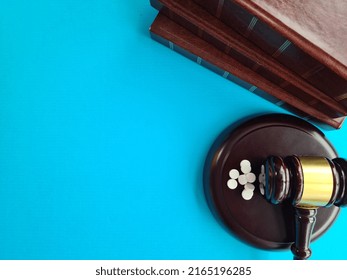 Drugs Law And Gavel Of Judge On Blue Background. Illegal Sale Of Drugs And A Court Verdict