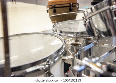 Drum band instruments during a performance with percussionists and rhythm section