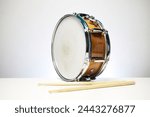 drum in brown isolated on white background with drum sticks 