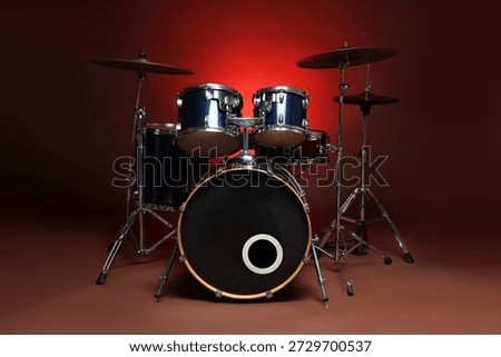 Drum kit on red gradient background. Musical instruments