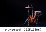 drum kit on stage on a dark background. Set of musical drums and guitars on stage. High quality photo