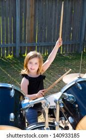 Drummer Blond Kid Girl Playing Drums In The Backyard Lawn