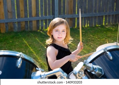 Drummer Blond Kid Girl Playing Drums In The Backyard Lawn