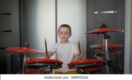 Drummer Boy Practicing Drumming At Home. A Young Boy As A Talented Drummer Of A Rock Band. A Beautiful And Cool American Teenager Plays A Drum Kit At Home.