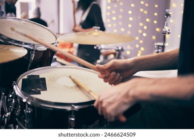 Drummer and hands at event with drums for band as musician in playing an instrument. Person, party and percussion as creative for entertainment, song or lyrics for online content or live performance - Powered by Shutterstock