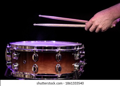 Drummer Playing Drum Sticks On A Snare Drum On Black Background Close Up.