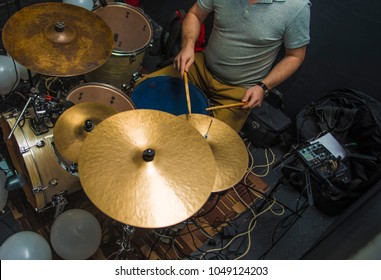 Drummer Playing On Drum Set Top View. Live Music Concert, Band Recording Process.Top View Side Of Electronic Modern Drum Kits Set In A Small Music Room