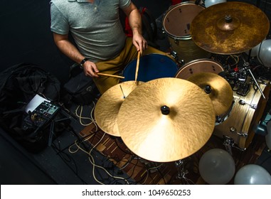 Drummer Playing On Drum Set Top View. Live Music Concert, Band Recording Process.Top View Side Of Electronic Modern Drum Kits Set In A Small Music Room