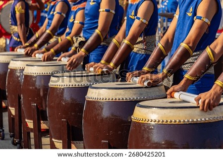 Drummers stand in rows, ready to play drums at various ceremonie