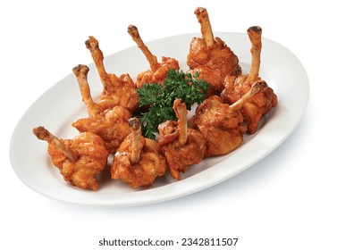 DRUMS OF HEAVEN, CHICKEN lollipops tossed in a sweet, spicy sauce on White Plate Isolated