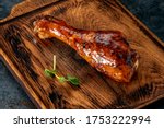 Drumstick chicken leg in barbecue sauce on a wooden chopping Board