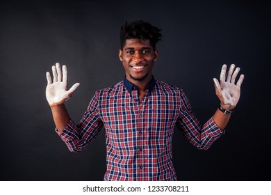 Drunk African American Afro Businessman Sloppy Man With Dreadlocks Hands Up Soiled In White Powder Dust Chemical Drug Police Arrest Cuba On A Black Background In The Studio.surrenders To The Police