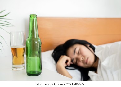 Drunk Asian Woman Drinking Bottle Of Beer Before Sleeping In Bed