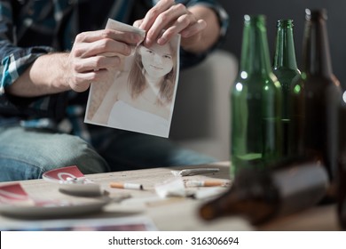 Drunk Boy Tearing Up A Photo Of Ex Girlfriend