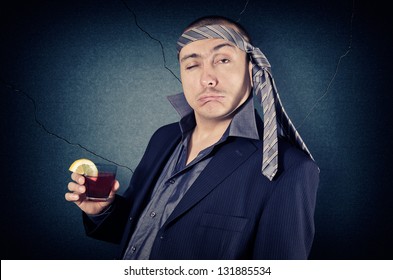 drunk businessman with tie on his head and a glass in her hand