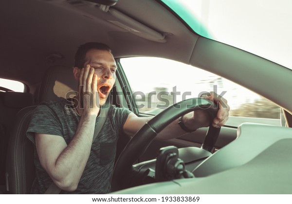 Drunk\
driver yawning and falling asleep rushes at high speed along road,\
breaking the rules and speeding violation. Drug intoxication while\
driving in motion. Problems and risk of\
accident.