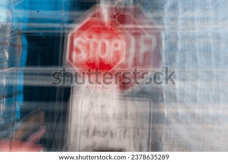 Drunk driving and mental illness danger concept background of an abstract icm intentional camera movement stop sign. Fear, alcoholism, drug use, traffic accident concepts in geometric urban setting