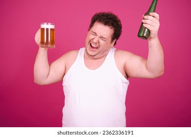 Drunk fat man posing on a pink background. Alcohol and a healthy lifestyle.