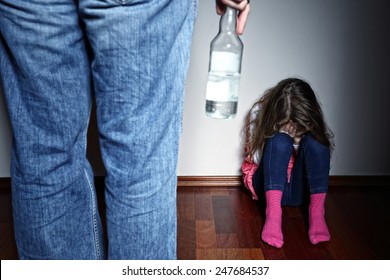 Drunk father standing over a crying daughter