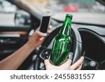 Drunk man driving a car on the road holding bottle beer Dangerous drunk driving concept