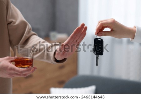 Drunk man refusing drive car while woman suggesting him keys, closeup. Don't drink and drive concept