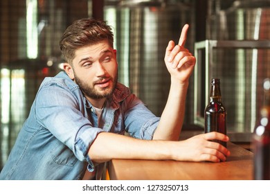 drunk man sitting at the bar counter and talking to barman
