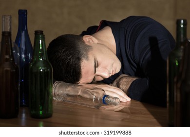 Drunk man sleeping on the table after party
