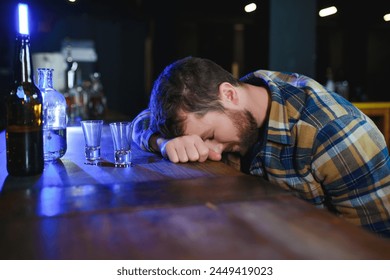 Drunk man sleeps at bar counter, alcohol addiction. - Powered by Shutterstock