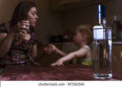 Drunk Mother With Alcoholic Drink Scolding Her Little Son. Alcohol Abuse, Female Alcoholism. Focus On Bottle.