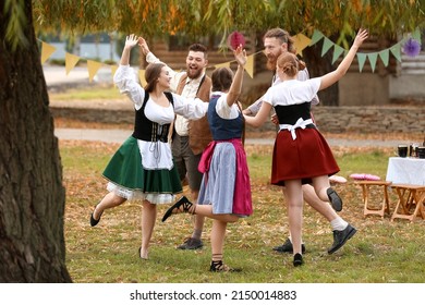 Drunk People Dancing And Celebrating Octoberfest Outdoors