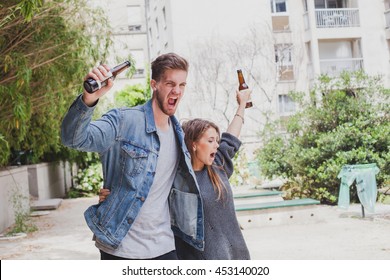drunk people singing on the street, young couple with beers