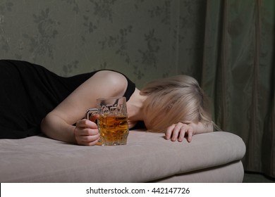 drunk woman alone in the room. Woman drinking beer and lying on the bed