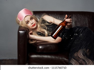 drunk woman looking at the bottle                       