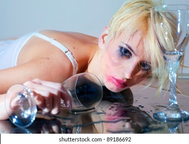 Drunk young woman with drinking glass