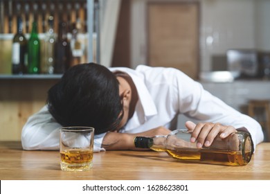 drunkard fall asleep on the table at bar.