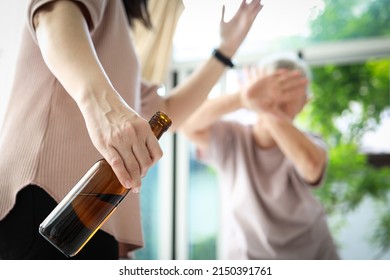 Drunken caregiver beating senior woman at nursing home,holding bottle of alcoholic drink,physically abuse the elderly while drinking alcohol,social danger,violence,aggression,alcohol addiction concept