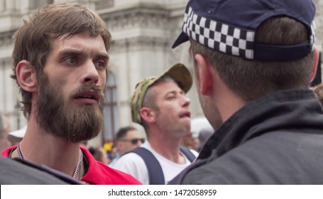 drunken man argue with the police at the Free Tommy Robinson protest outside along Whitehall in London, UK, 03/08/19