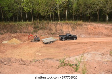 Drving Soil Out From The Place By Using Excavator And Car Trailer.